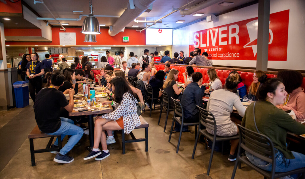 Photo of a pizzeria full of people